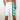 Chi Chi Sport white basketball shorts with green side stripes and shamrock print, 10-inch inseam, back view.