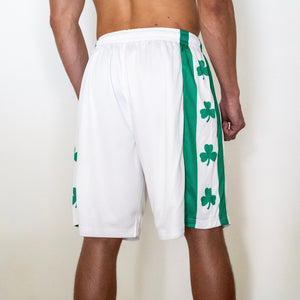 Chi Chi Sport white basketball shorts with green side stripes and shamrock print, 10-inch inseam, back view.