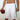 Chi Chi Sport men's white basketball shorts with green side stripes and a 10-inch inseam, worn by a male model.